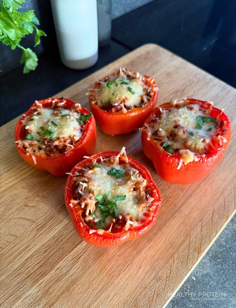 Stuffed peppers meal with ground meat, rice, tomato sauce, and melted cheese baked in the oven
