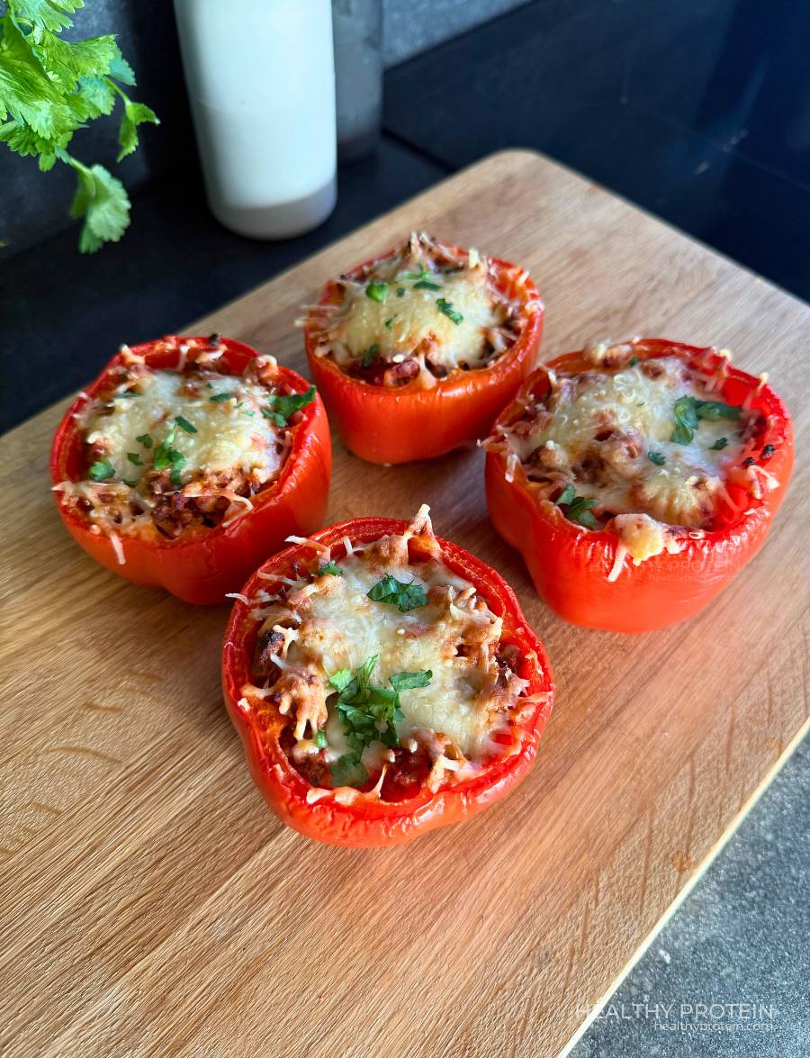 Stuffed peppers meal with ground meat, rice, tomato sauce, and melted cheese baked in the oven